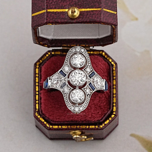 art deco old european three-round cut diamond engagement ring on jewelry box