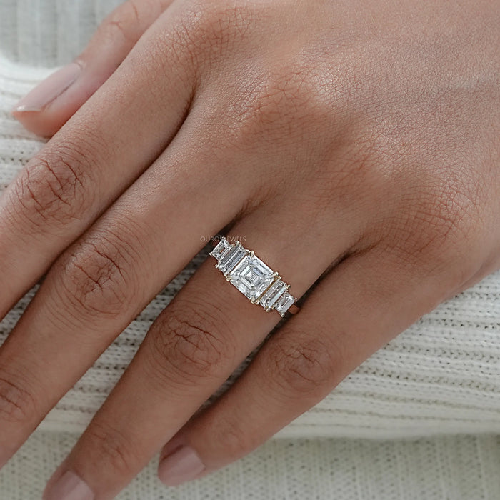 asscher and baguette cut lab diamond five stone engagement ring on model's finger