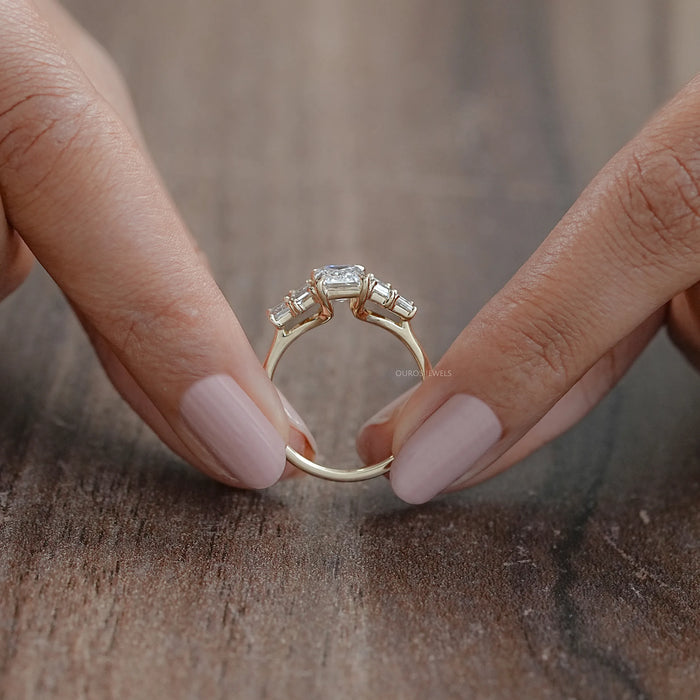 close view of emerald and baguette cut lab diamond five stone engagement ring