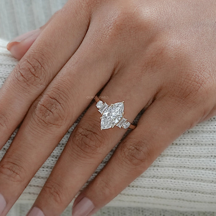 marquise and baguette cut diamond five stone engagement ring on model's finger