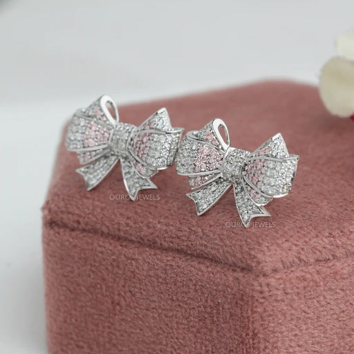 side view of round cut cluster diamond pink bow earrings silver push back