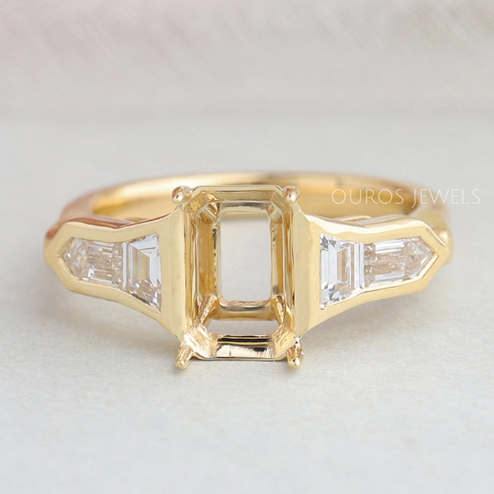 front view of bullet diamond and trapezoid-cut semi-mount engagement ring on fabric