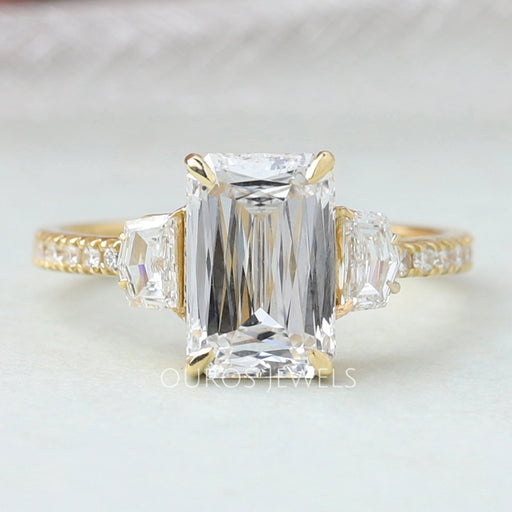 front view of criss cut diamond three stone engagement ring with yellow gold band