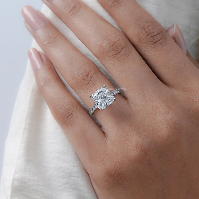 cushion cut lab diamond solitaire hidden halo engagement ring on model's finger