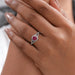 cushion cut red ruby halo split shank engagement ring on model's finger