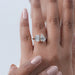 pear and emerald cut lab diamond two-stone toi et moi engagement ring in finger