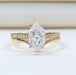 front view of dutch marquise-cut diamond curved engagement ring set with 2 yellow bands
