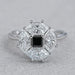 top view of princess cut lab diamond dutch marquise halo ring on grey fabric