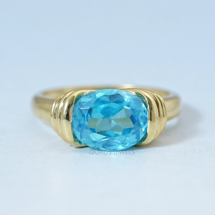 top view of east west blue oval gemstone solitaire wedding ring