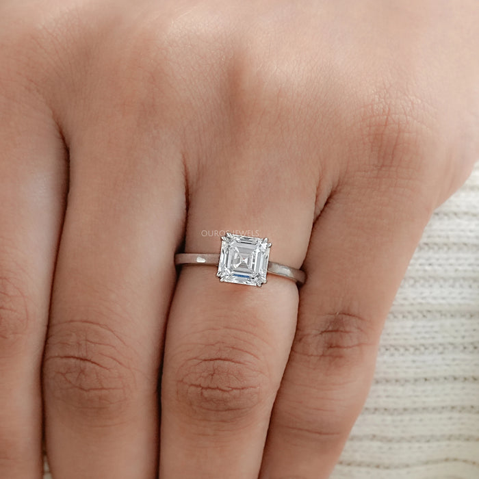 asscher cut diamond double prong engagement ring in finger