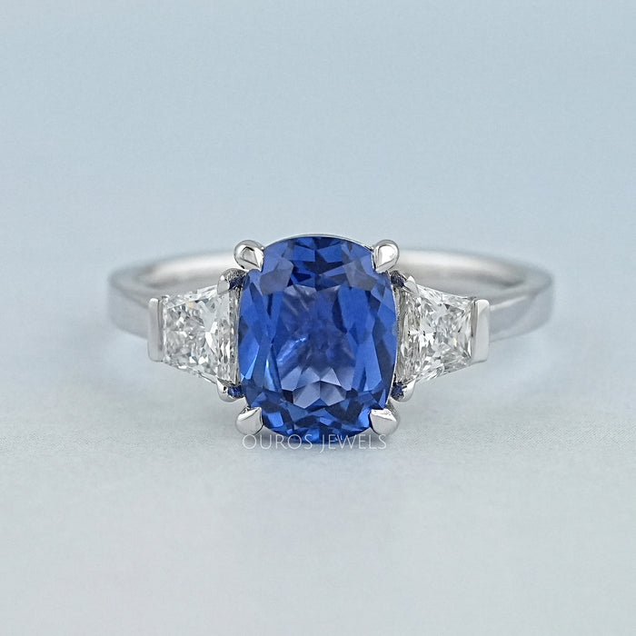 front view of sapphire cushion gemstone with trapezoid diamond 3 stone wedding ring