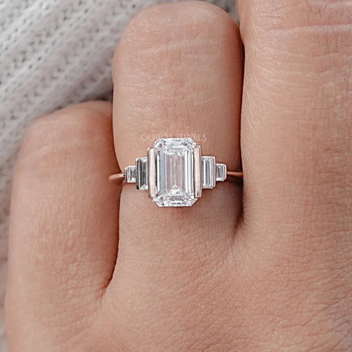 front view of emerald-cut diamond half bezel set solitaire accent engagement ring