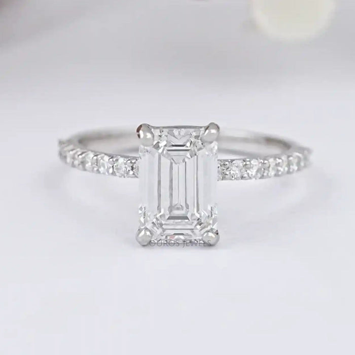 front view of igi certified emerald cut diamond solitaire accent ring on grey fabric