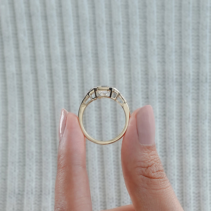 close view of asscher and trapezoid cut lab diamond bezel five stone wedding ring