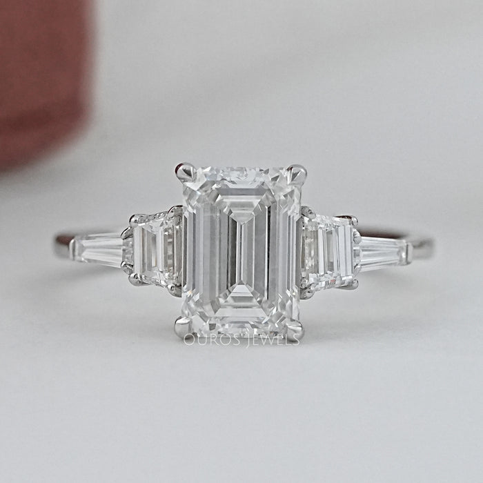 front view of emerald cut and trapezoid lab diamond five stone engagement ring