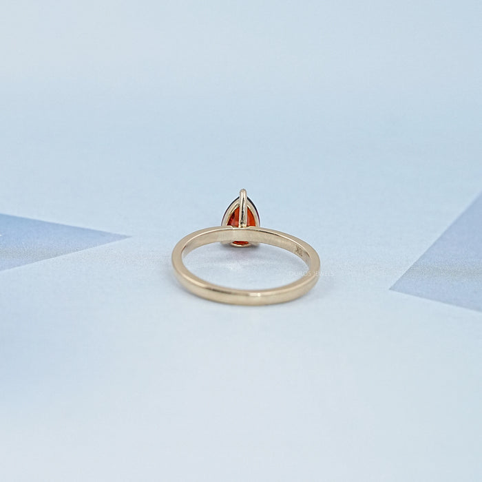 back view of garnet pear-cut gemstone solitaire engagement ring