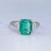 front view of green cushion and half moon cut lab diamond three stone engagement ring