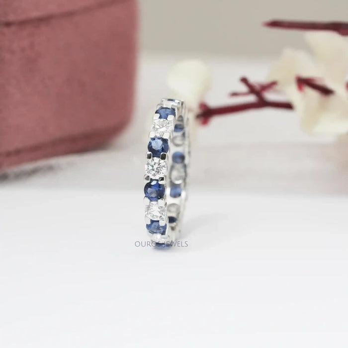 side view of blue round cut lab grown diamond eternity band