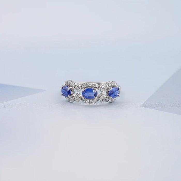 Image of gorgeous three stone oval sapphire halo ring