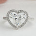 heart cut lab diamond halo engagement ring's front angle view on grey fabric