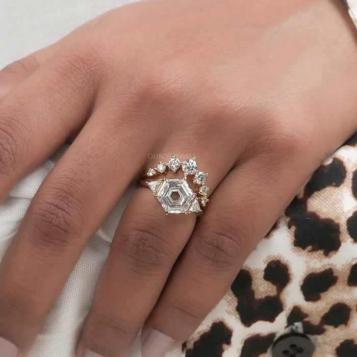 antique hexagon-cut diamond curved three-stone bridal ring set on model's finger