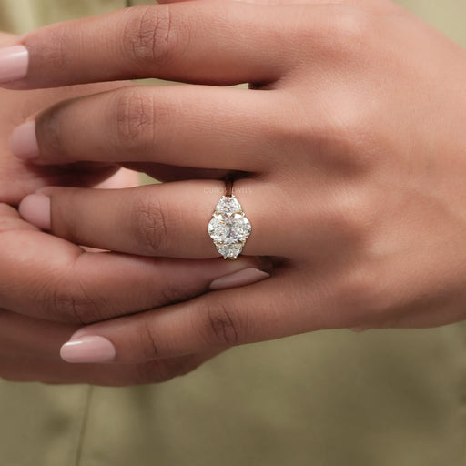oval cut lab diamond three stone engagement ring on model's finger