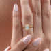 emerald cut lab diamond bezel set solitaire engagement ring in hand