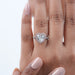 heart-shaped diamond pink halo engagement ring on model's hand