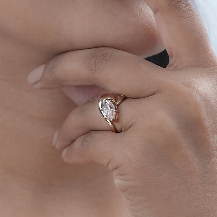 pink marquise cut diamond bypass engagement ring yellow gold in model's hand