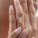 pear cut diamond bezel set solitaire engagement ring in finger