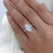 oval-cut lab grown diamond solitaire accent engagement ring in finger