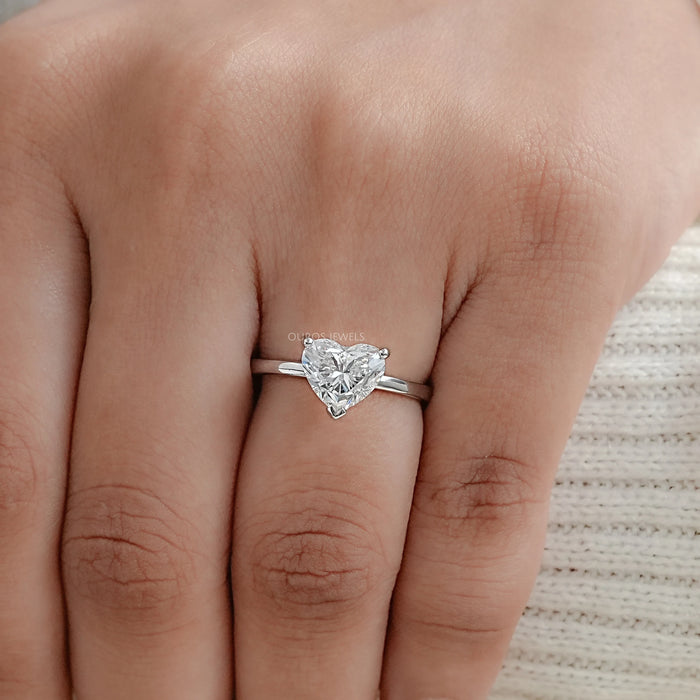 heart cut lab grown diamond solitaire proposal ring in finger