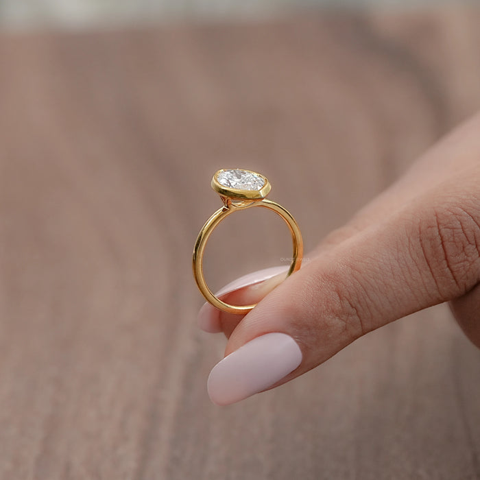 side view of marquise cut lab diamond bezel set solitaire engagement ring