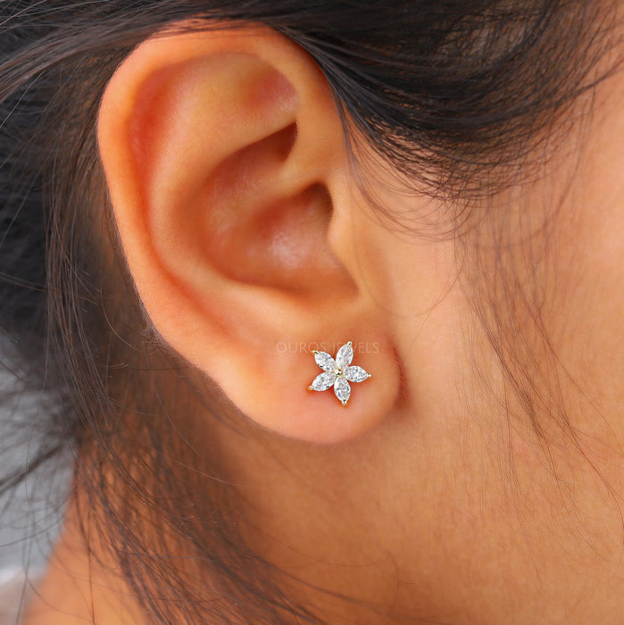 marquise cut manufactured diamond flower stud earrings yellow gold on ear