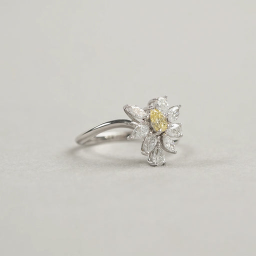 side view of yellow pear and marquise-cut cluster diamond colored engagement ring