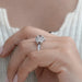square old mine cushion diamond five stone halo engagement ring on model's finger