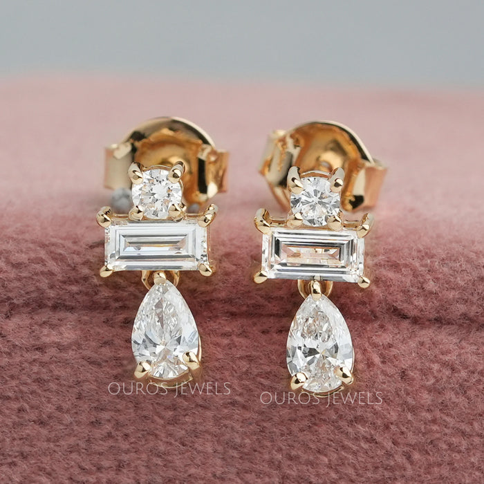 front view of pear and baguette cut diamond prong setting drop earrings gold