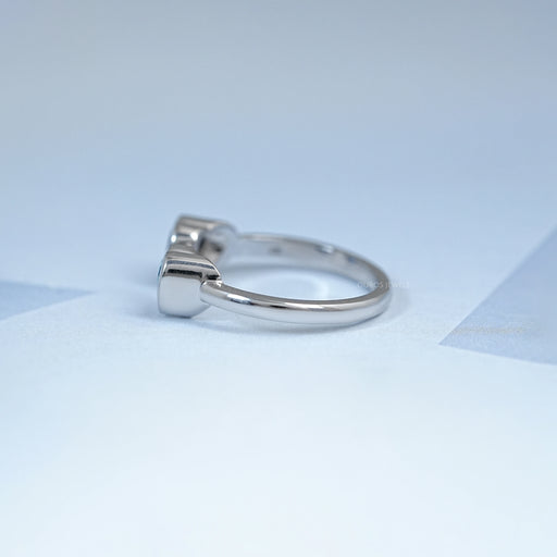 side view of blue sapphire and zircon heart gemstone toi et moi wedding ring