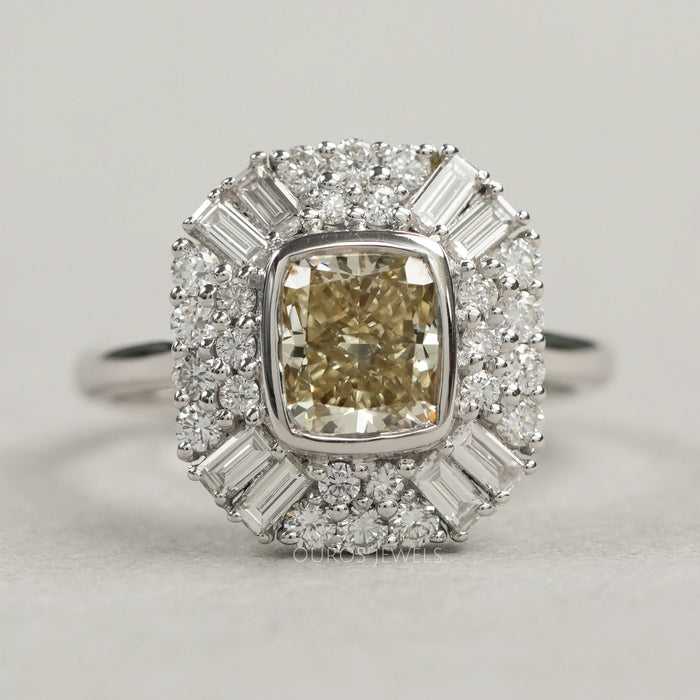 top view of yellow cushion cut diamond bezel set halo cluster engagement ring