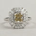 top view of yellow cushion cut diamond bezel set halo cluster engagement ring