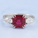 front view of asscher cut ruby and pear diamond double prong 3 stone wedding ring