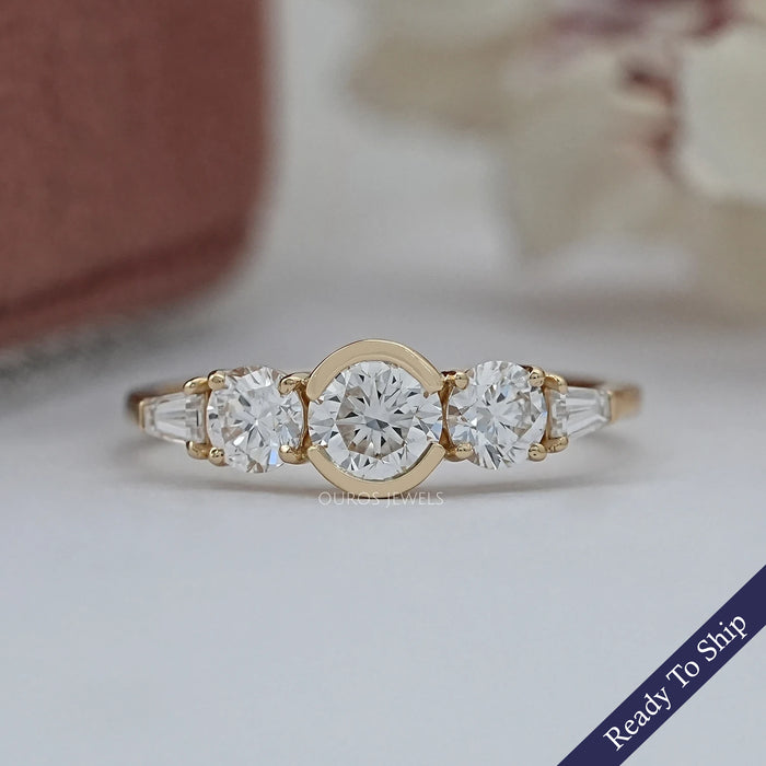top view of round and tapered baguette diamond half bezel five stone engagement ring