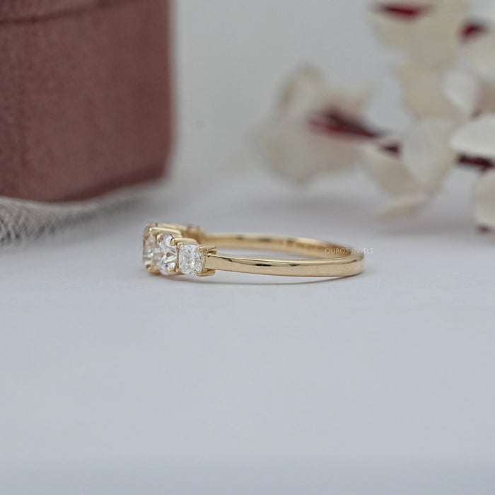 side view of cushion and round cut lab diamond five stone engagement ring