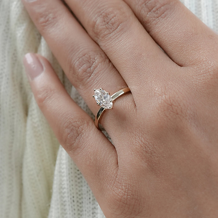 marquise cut diamond solitaire engagement ring with prong setting in finger