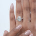 top view of oval cut lab diamond halo engagement ring in finger