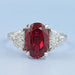 front view of oval ruby gemstone and half moon diamond 3 stone engagement ring