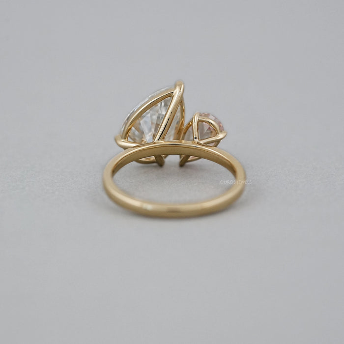 back view of pear lab diamond dual toi et moi engagement ring on grey fabric