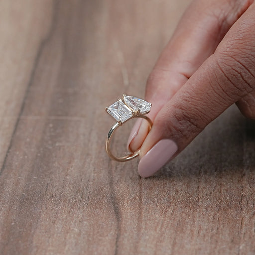 side view of pear and emerald cut lab diamond two-stone toi et moi engagement ring