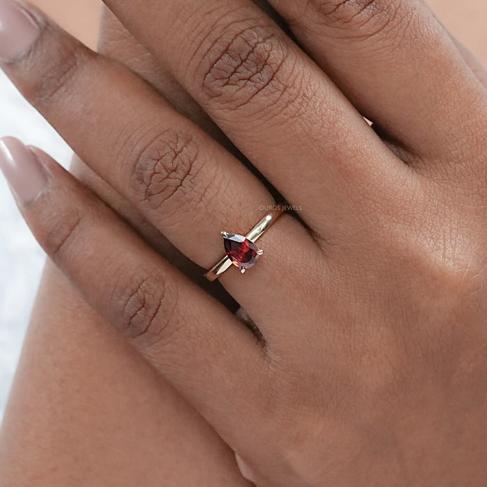 garnet pear-cut gemstone engagement ring in finger
