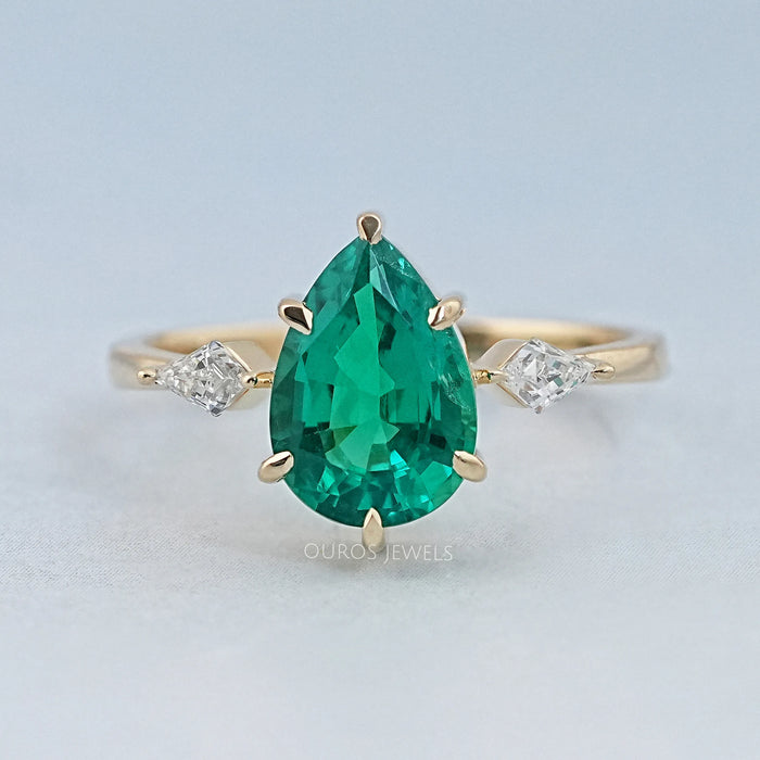 front view of green pear gemstone and kite cut diamond three stone engagement ring
